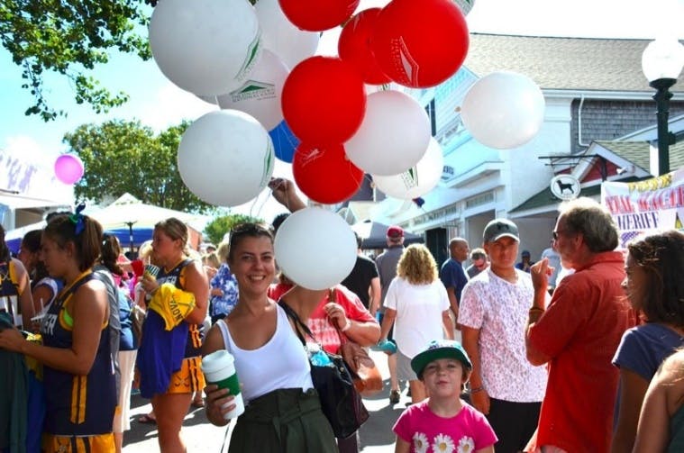 Girl with red balloons at Tivoli Day on Circuit Avenue in Oak Bluffs, MA